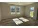 Light filled sun room featuring two windows and an exterior glass door at 111 Magnolia Run Way, Benson, NC 27504