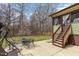 Backyard patio area with outdoor seating and stairs to a sunroom, perfect for entertaining and relaxation at 111 Preakness Dr, Archer Lodge, NC 27527