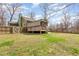 Spacious backyard featuring a deck, patio area, lush lawn, and mature trees providing privacy at 111 Preakness Dr, Archer Lodge, NC 27527