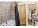 Bathroom with a tiled shower and a wood-look door with a unique rustic finish and hardware at 111 Preakness Dr, Archer Lodge, NC 27527