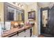 Charming bathroom features a rustic vanity with a copper sink, a decorative mirror and a barn door to the closet at 111 Preakness Dr, Archer Lodge, NC 27527