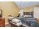 Cozy bedroom featuring warm toned walls, a comfortable bed and wooden dresser at 111 Preakness Dr, Archer Lodge, NC 27527