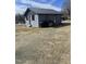 Cozy home with muted blue exterior paint, standing seam metal roof, and two entrance doors at 1204 Avondale Dr, Burlington, NC 27217