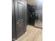 A kitchen and adjacent doorway with dark walls and stainless steel refrigerator for easy access at 1204 Avondale Dr, Burlington, NC 27217