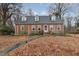 Charming brick home with a well-maintained front yard and mature trees at 1303 Rainy St, Burlington, NC 27217