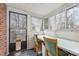 Bright sunroom with multiple windows, white trim, and a table with chairs, offering a cozy space at 1303 Rainy St, Burlington, NC 27217