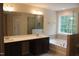 Bathroom boasts a double sink vanity, soaker tub, large mirror, and walk-in shower at 1414 Reading Ct # 91Kl, Burlington, NC 27217