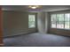 Bright bedroom featuring neutral paint, carpet, and dual windows offering ample natural light at 1414 Reading Ct # 91Kl, Burlington, NC 27217