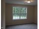 Well-lit bedroom featuring a large window providing outdoor views at 1414 Reading Ct # 91Kl, Burlington, NC 27217