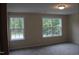 Comfortable bedroom featuring two windows for natural light and views at 1414 Reading Ct # 91Kl, Burlington, NC 27217