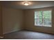 Cozy bedroom with a large window that offers natural light and neighborhood views at 1414 Reading Ct # 91Kl, Burlington, NC 27217