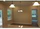 Bright dining area featuring windows and glass doors for scenic views and natural light at 1414 Reading Ct # 91Kl, Burlington, NC 27217