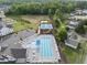 Aerial view of community pool, tennis courts, playground, and parking at 15 Nimble Way # 175, Clayton, NC 27520