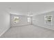 Large bonus room features soft carpet, windows, and ceiling fan at 15 Nimble Way # 175, Clayton, NC 27520