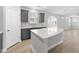 Bright kitchen features a large island, gray cabinetry, and modern finishes at 15 Nimble Way # 175, Clayton, NC 27520