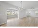 Large open-concept living space with luxury vinyl plank flooring and modern chandelier at 15 Nimble Way # 175, Clayton, NC 27520