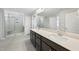 Modern main bathroom with dual sinks, a large mirror, and glass shower at 15 Nimble Way # 175, Clayton, NC 27520
