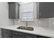 Close-up on the sink and counter with white backsplash and gray cabinets at 15 Nimble Way # 175, Clayton, NC 27520