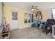 A sunny sunroom with light yellow walls, a ceiling fan, and light colored floors at 1721 Kingston Heath Way, Raleigh, NC 27604