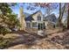 Back exterior of charming home featuring a spacious wooden deck and screened in porch at 1721 Kingston Heath Way, Raleigh, NC 27604