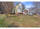 Charming two-story home with a well-manicured lawn and mature trees at 1721 Kingston Heath Way, Raleigh, NC 27604