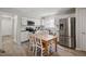 Bright kitchen with stainless steel appliances, granite countertops, and dining area at 1721 Kingston Heath Way, Raleigh, NC 27604