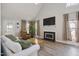 Bright living room with vaulted ceilings, hardwood floors, fireplace, and comfortable seating at 1721 Kingston Heath Way, Raleigh, NC 27604