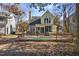 A charming two-story home with a spacious backyard and wooden deck surrounded by trees at 1721 Kingston Heath Way, Raleigh, NC 27604