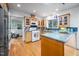 Bright kitchen features custom wood cabinets, granite countertops, and an island, with hardwood floors at 1824 S Lakeshore Dr, Chapel Hill, NC 27514