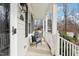 Covered front porch with cozy seating area, offering a great view of the neighborhood at 19 Juneberry Pl, Clayton, NC 27527