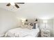 Well-lit main bedroom features a ceiling fan, side tables, and a decorative headboard at 19 Juneberry Pl, Clayton, NC 27527