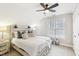 Cozy main bedroom has natural light, decorative pillows, ceiling fan, and bedside tables at 19 Juneberry Pl, Clayton, NC 27527