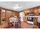 Open kitchen layout with dining area, wood cabinetry, and ample counter space at 201 N Holt St, Pine Level, NC 27568