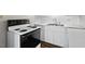 Close up of the kitchen with black and white appliances and a stainless steel sink at 2107 Markham Dr, Chapel Hill, NC 27514