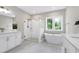 Luxurious bathroom featuring a standalone tub, walk-in shower with a bench, and stylish double vanities at 213 W Weatherford Dr, Angier, NC 27501
