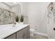 Full bathroom featuring a vanity with cabinet storage, a mirror, toilet, and shower with light neutral colors at 213 W Weatherford Dr, Angier, NC 27501