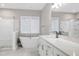 Elegant bathroom featuring a soaking tub, walk-in shower with glass door, and a modern vanity with double sinks at 213 W Weatherford Dr, Angier, NC 27501