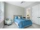 This bedroom features a stylish blue bedspread, plush carpeting, and a cozy accent chair at 213 W Weatherford Dr, Angier, NC 27501