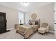 Cozy bedroom with neutral tones, a comfortable bed, and a decorative tree-of-life wall art at 213 W Weatherford Dr, Angier, NC 27501
