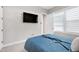 Bedroom showcasing a flat screen television, windows with blinds, and neutral walls at 213 W Weatherford Dr, Angier, NC 27501