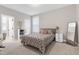 Bedroom with a bed, a writing desk, and view of a shelf displaying decorative items at 213 W Weatherford Dr, Angier, NC 27501