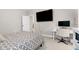 Bedroom with carpet, a bed, TV, desk, and large window at 213 W Weatherford Dr, Angier, NC 27501