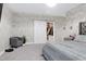Primary bedroom with closet, chair, and a view of the sliding barn door at 213 W Weatherford Dr, Angier, NC 27501