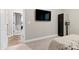 Bedroom showcasing a mounted TV and doorway leading to an adjacent room at 213 W Weatherford Dr, Angier, NC 27501