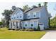 Charming two-story home with blue siding, well-manicured lawn, and inviting front porch at 213 W Weatherford Dr, Angier, NC 27501