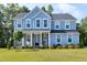 Charming two-story home featuring blue siding, stone accents, and a welcoming front porch at 213 W Weatherford Dr, Angier, NC 27501