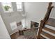A grand foyer showcases a modern chandelier, wood staircase, and a welcoming entryway to the home's interior at 213 W Weatherford Dr, Angier, NC 27501