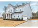 Charming two-story home with a well-kept lawn and attached garage at 213 W Weatherford Dr, Angier, NC 27501