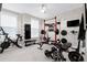 Home gym equipped with weight machines, exercise bikes, a mounted TV, and ample space for workouts at 213 W Weatherford Dr, Angier, NC 27501