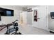 Home gym with weight machines, equipment, and mounted TV, offering a convenient space for fitness at 213 W Weatherford Dr, Angier, NC 27501